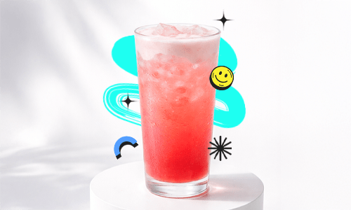 A refreshing Berry Lemon Twist Recipe drink in a tall glass with ice and light foam, placed on a white podium with a bright aesthetic background