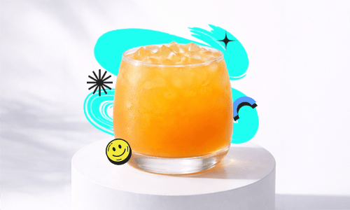 A refreshing Iced Mango Peach drink in a short round glass with ice placed on a white podium with a bright aesthetic background