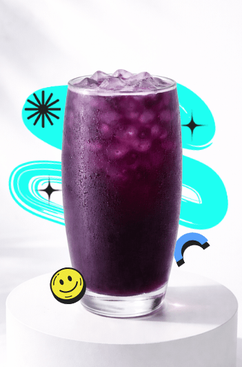A vibrant Mixed Berry Refresher Recipe drink in a tall glass with ice, deep purple color, placed on a white podium with a bright aesthetic background