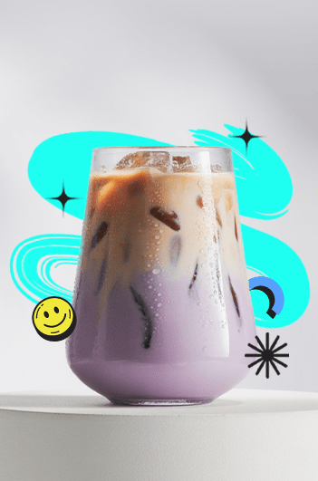 A creamy dreamy taro milktea in a clear cup with rich purple color, topped with milk foam and served cold