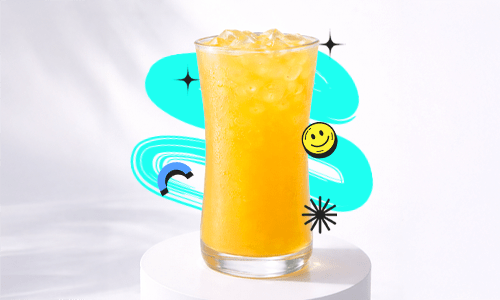 A refreshing Kumquat Lemon Pop Recipe drink in a tall curvy glass with ice, placed on a white podium with a bright aesthetic background