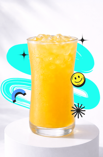 A refreshing Kumquat Lemon Pop Recipe drink in a tall curvy glass with ice, placed on a white podium with a bright aesthetic background